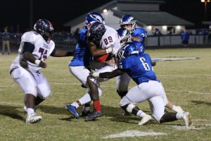 East Lake defenders (including LB Karsan Lilley) making a tackle on a Tampa Bay Tech player in Round Two of the FHSAA Class 7A Football Playoffs